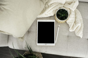 Tablet on couch with plants