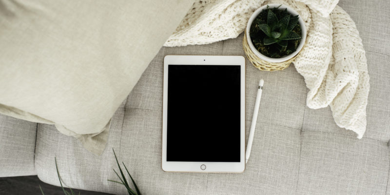 Tablet on couch with plants