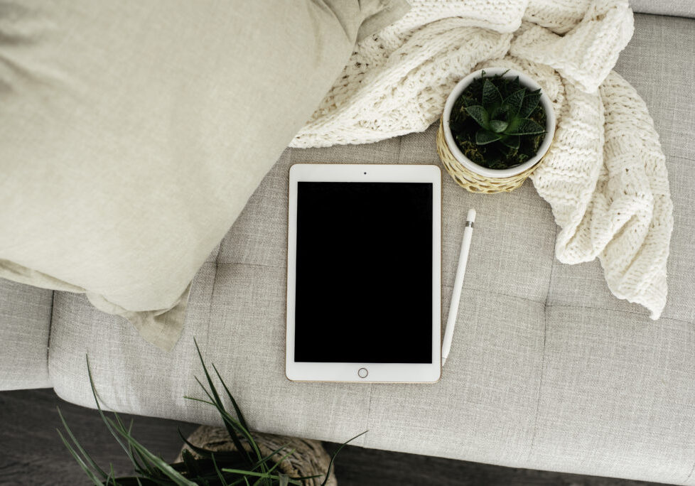 Tablet on couch with plants